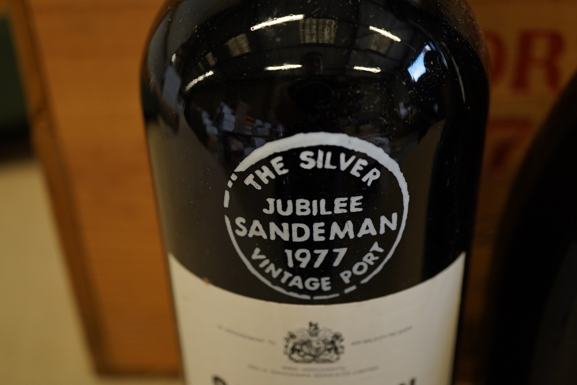 Twelve bottles of 1977 Sandeman vintage port (O.W.C but opened), and a cased bottle of 1978 Dom Perignon champagne